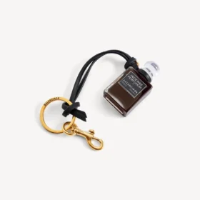 Bedeltje in de vorm van een miniatuurparfumflesje in zwart