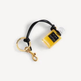 Bedeltje in de vorm van een miniatuurparfumflesje in zwart
